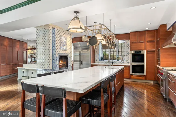 a large kitchen with stainless steel appliances granite countertop a large island in the center