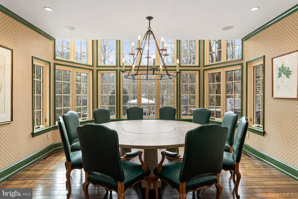 a living room with furniture dining table and a large window