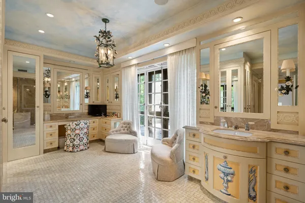 a bathroom with a sink a toilet and a large mirror