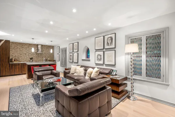 a dining room with furniture a chandelier and glass windows