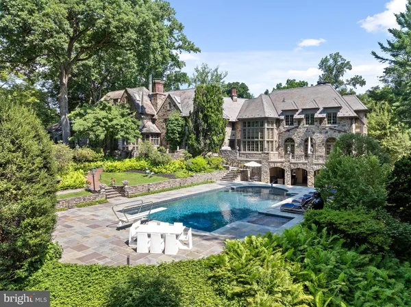 an aerial view of a house with swimming pool garden and patio