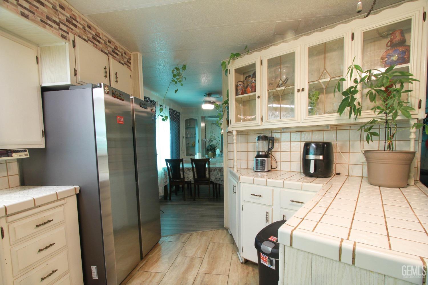 Undisclosed Address Bakersfield, CA 93304 - Photo 11 of 27 a kitchen with a refrigerator and a stove