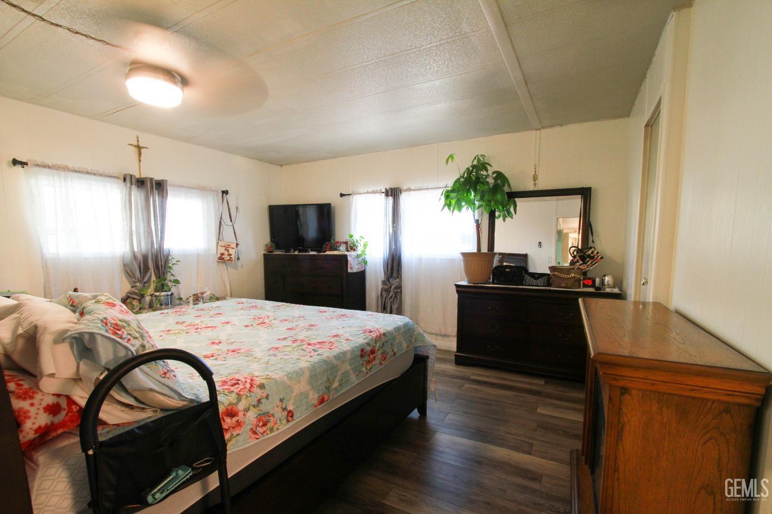 Undisclosed Address Bakersfield, CA 93304 - Photo 15 of 27 a bedroom with a bed and a dresser