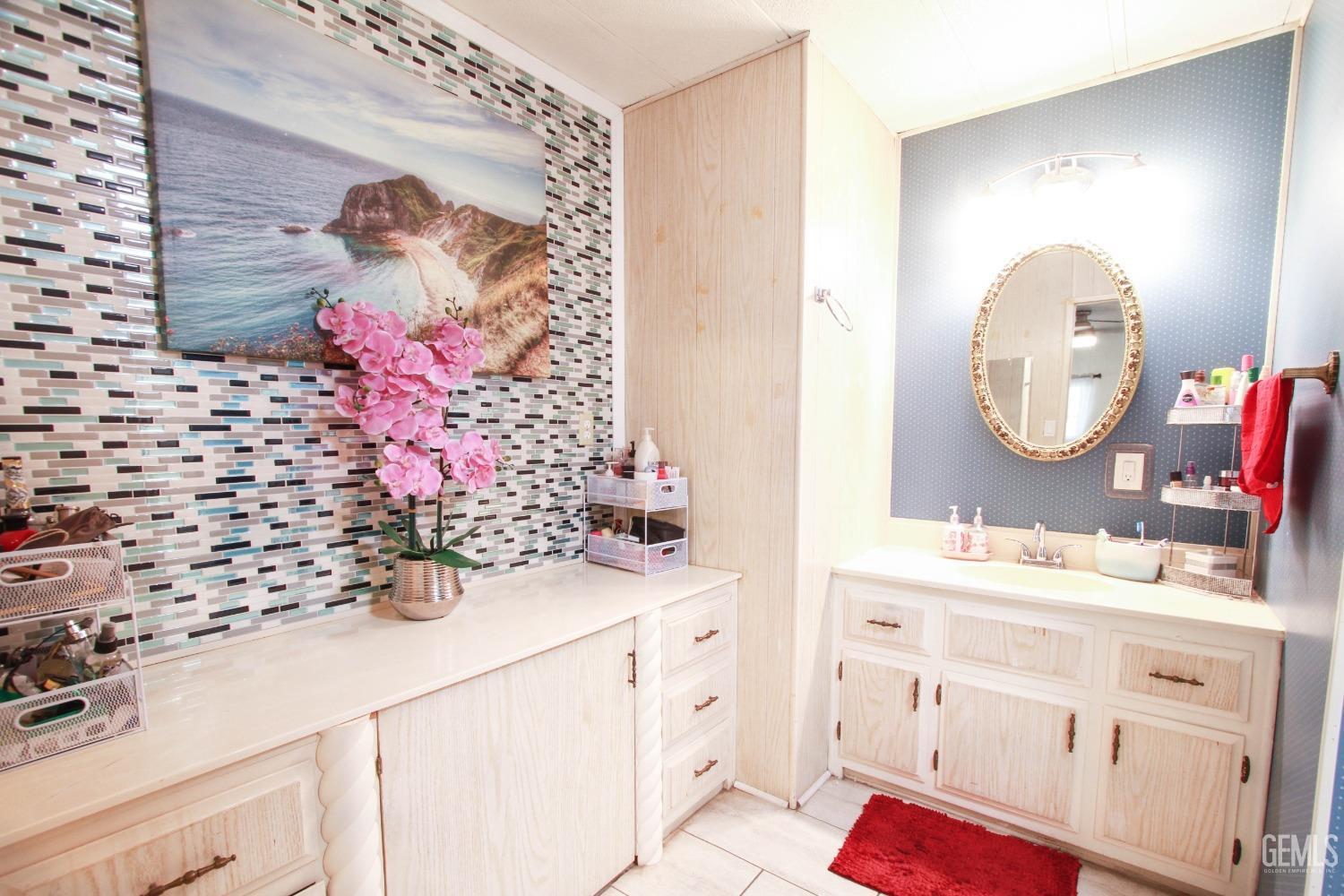 Undisclosed Address Bakersfield, CA 93304 - Photo 17 of 27 a bathroom with a sink mirror and vanity