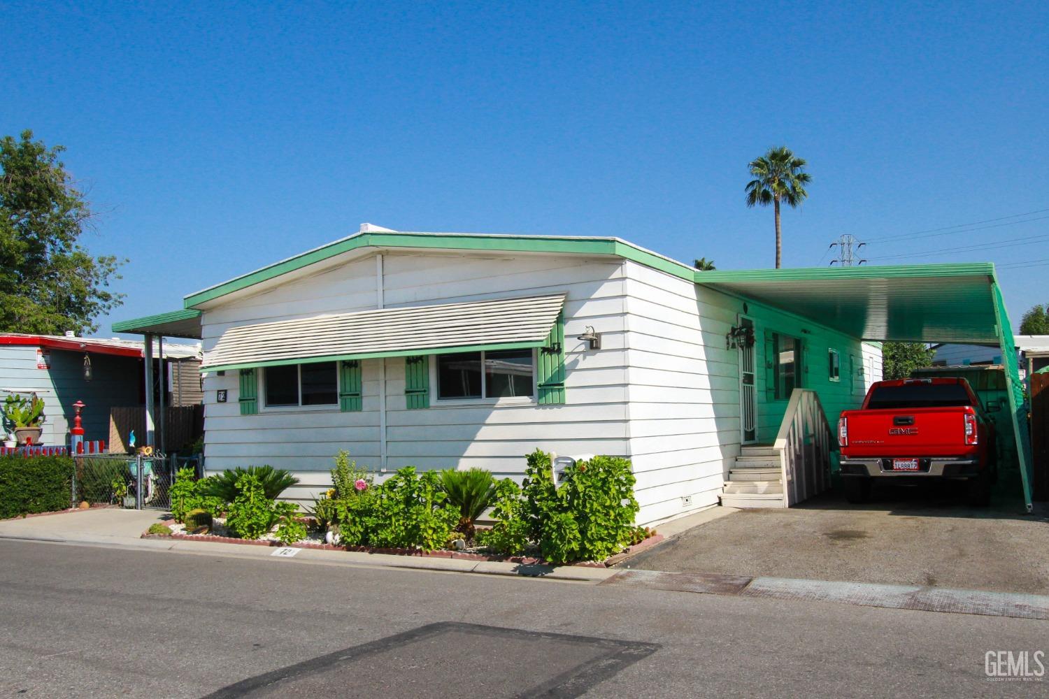 Undisclosed Address Bakersfield, CA 93304 - Photo 2 of 27 a front view of a house with a yard