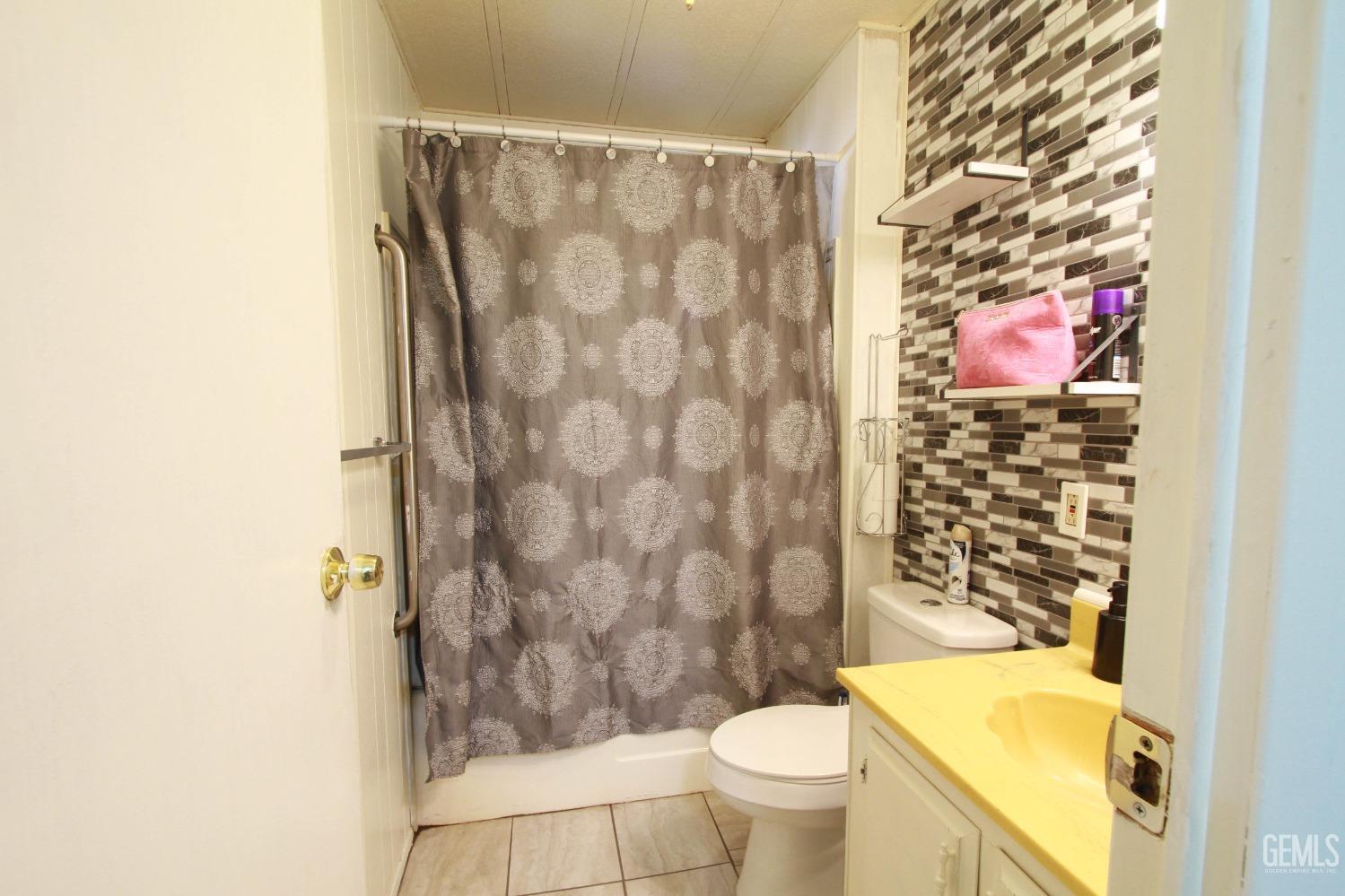 Undisclosed Address Bakersfield, CA 93304 - Photo 22 of 27 a bathroom with a toilet and shower