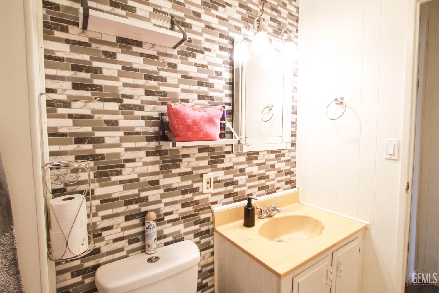 Undisclosed Address Bakersfield, CA 93304 - Photo 23 of 27 a bathroom with a sink toilet and mirror