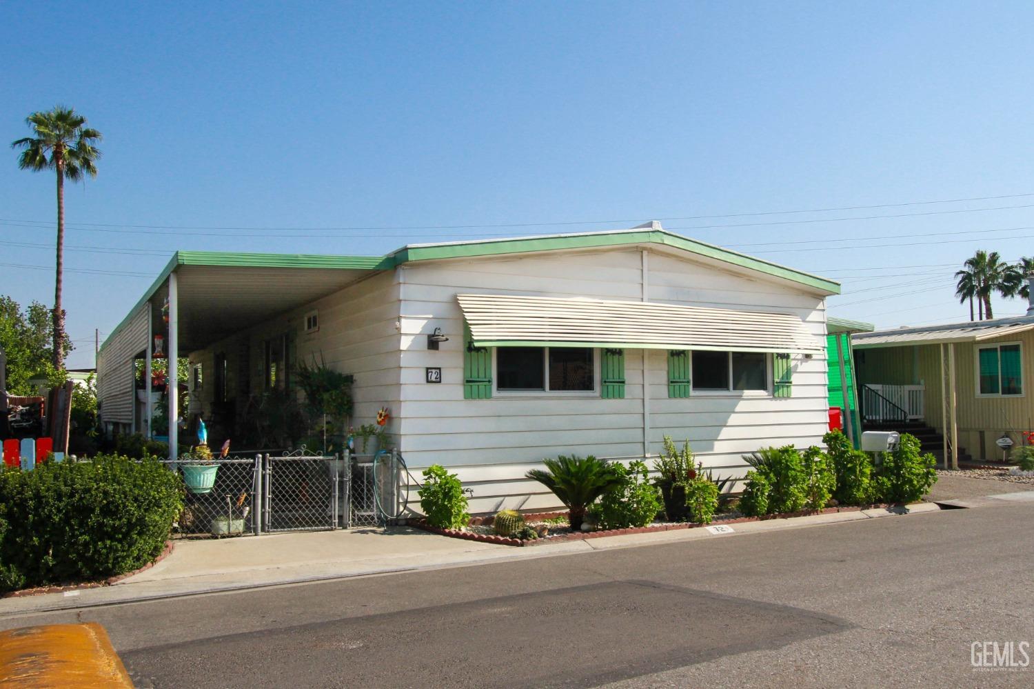 Undisclosed Address Bakersfield, CA 93304 - Photo 3 of 27 a front view of a house with a yard