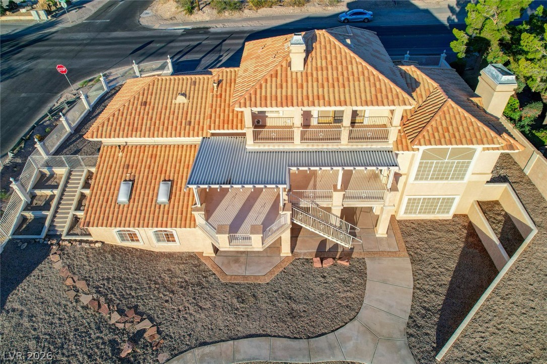 640 North Racetrack Road Henderson, NV 89015 - Photo 12 of 65 An aerial perspective reveals the home's distinctive tiled rooflines and multi-level balconies, offering unique outdoor living spaces.