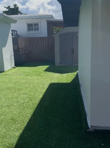 a view of a backyard with sitting area