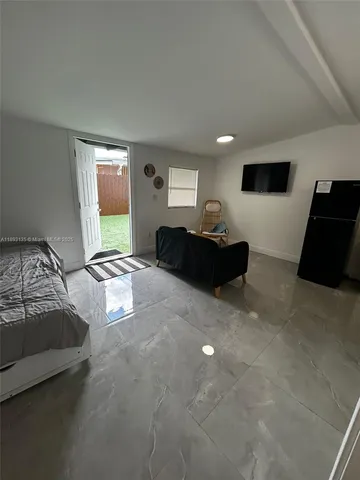 a kitchen with stainless steel appliances granite countertop a refrigerator and a stove