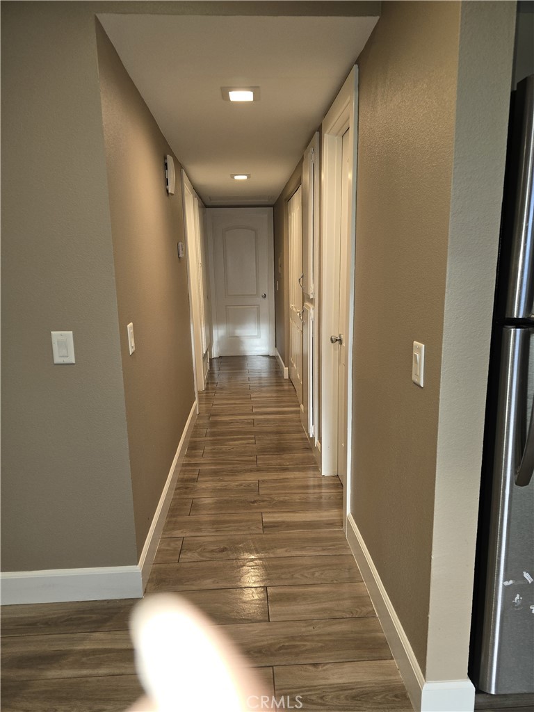 1370 Wheaton Way Riverside, CA 92507 - Photo 11 of 17 a view of a hallway with wooden floor and staircase