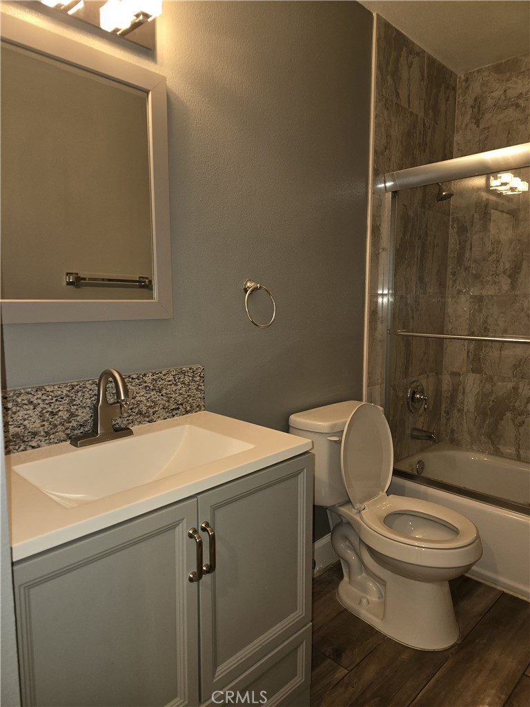 1370 Wheaton Way Riverside, CA 92507 - Photo 12 of 17 a bathroom with a sink a toilet and a mirror