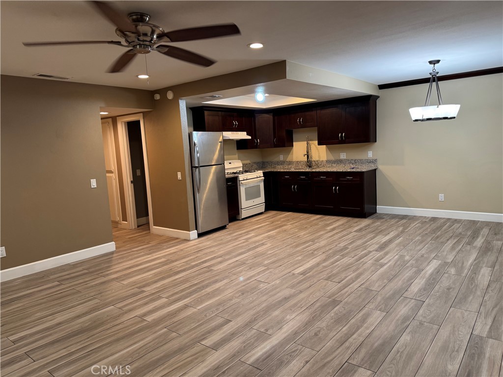 1370 Wheaton Way Riverside, CA 92507 - Photo 2 of 17 an open kitchen with a refrigerator and microwave