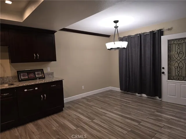 a room with wooden floor closet and window