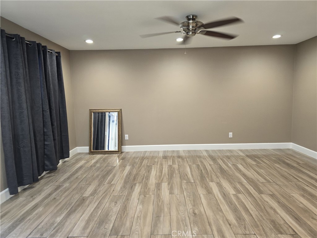 1370 Wheaton Way Riverside, CA 92507 - Photo 6 of 17 en empty room with wooden floor and windows