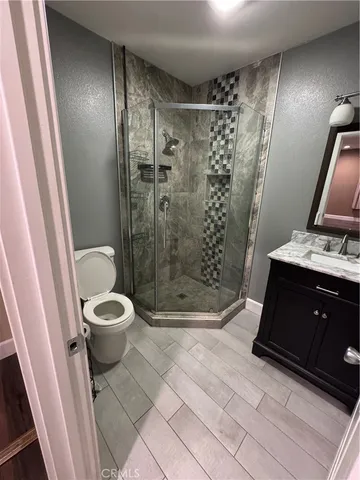 a bathroom with a toilet and a shower