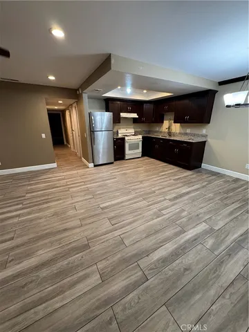 a kitchen with stainless steel appliances kitchen island granite countertop a sink and cabinets