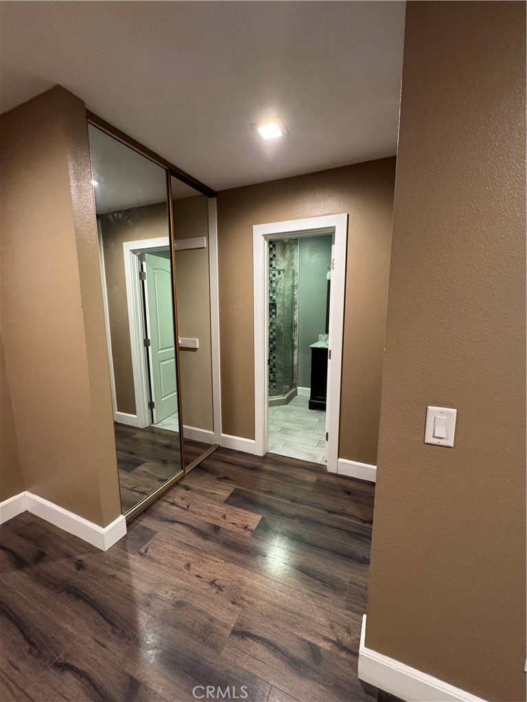 1370 Wheaton Way Riverside, CA 92507 - Photo 10 of 17 a view of an empty room with wooden floor and a mirror