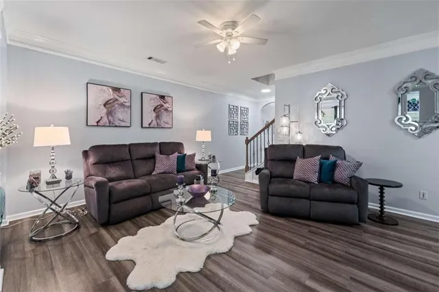 a living room with furniture and wooden floor