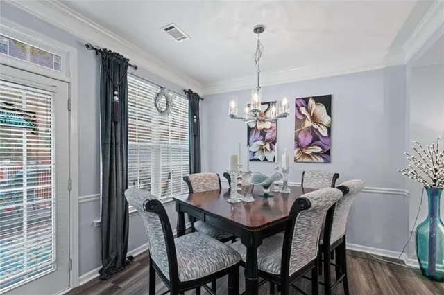 a kitchen with a refrigerator a stove a sink cabinets and wooden floor