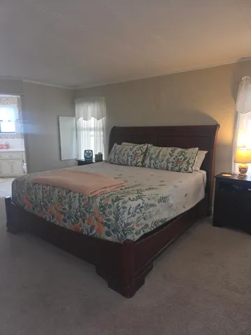 a living room with furniture a flat screen tv and a floor to ceiling window