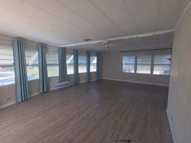 a view of a dining room with furniture and a kitchen