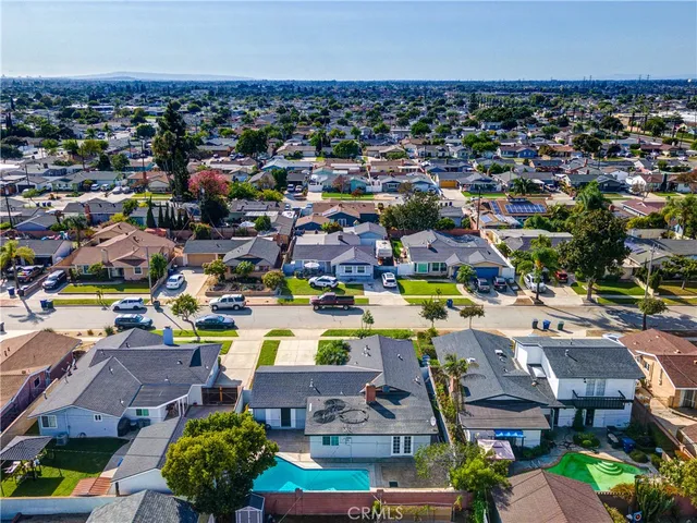 an aerial view of a houses with a swimming pool