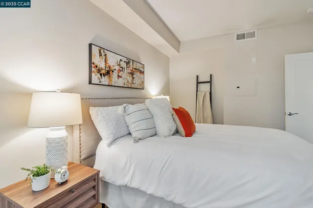 a bedroom with a bed and a lamp