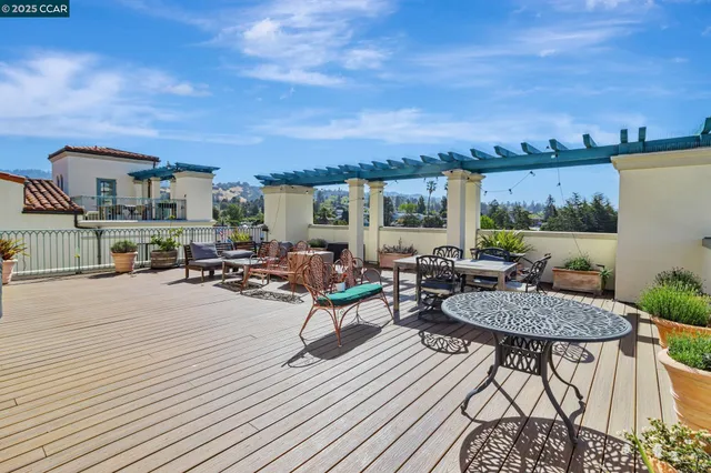a view of a terrace with furniture and a kitchen