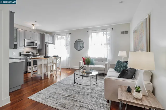 a living room with furniture a wooden floor and a fireplace