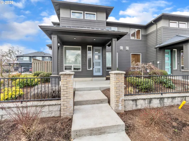 a view of a house with a small deck
