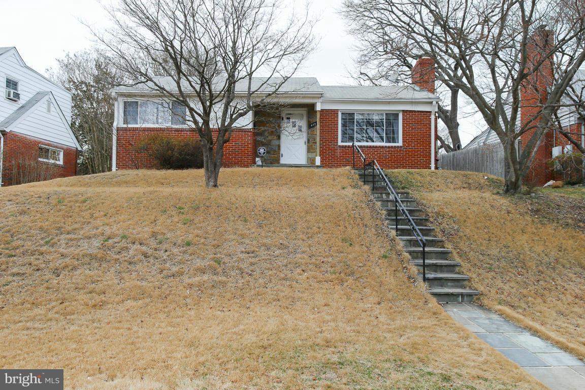 417 Kerwin Road Silver Spring, MD 20901 - Photo 1 of 30 a front view of a house with a yard covered in snow