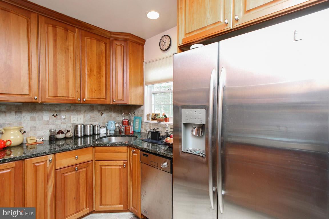 417 Kerwin Road Silver Spring, MD 20901 - Photo 13 of 30 a kitchen with stainless steel appliances granite countertop a refrigerator and a sink