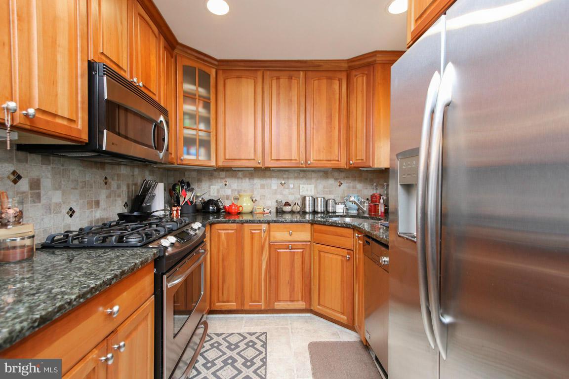 417 Kerwin Road Silver Spring, MD 20901 - Photo 14 of 30 a kitchen with stainless steel appliances granite countertop a stove a sink and a refrigerator