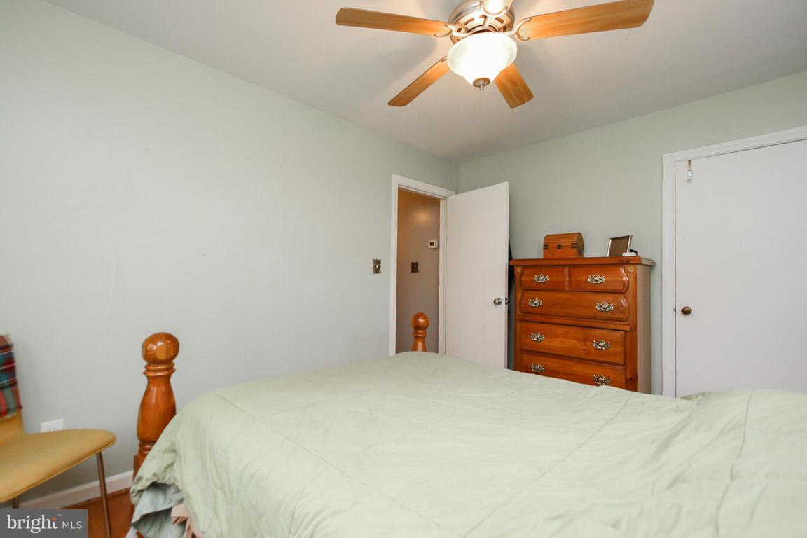 417 Kerwin Road Silver Spring, MD 20901 - Photo 15 of 30 a bed room with a bed and a chandelier