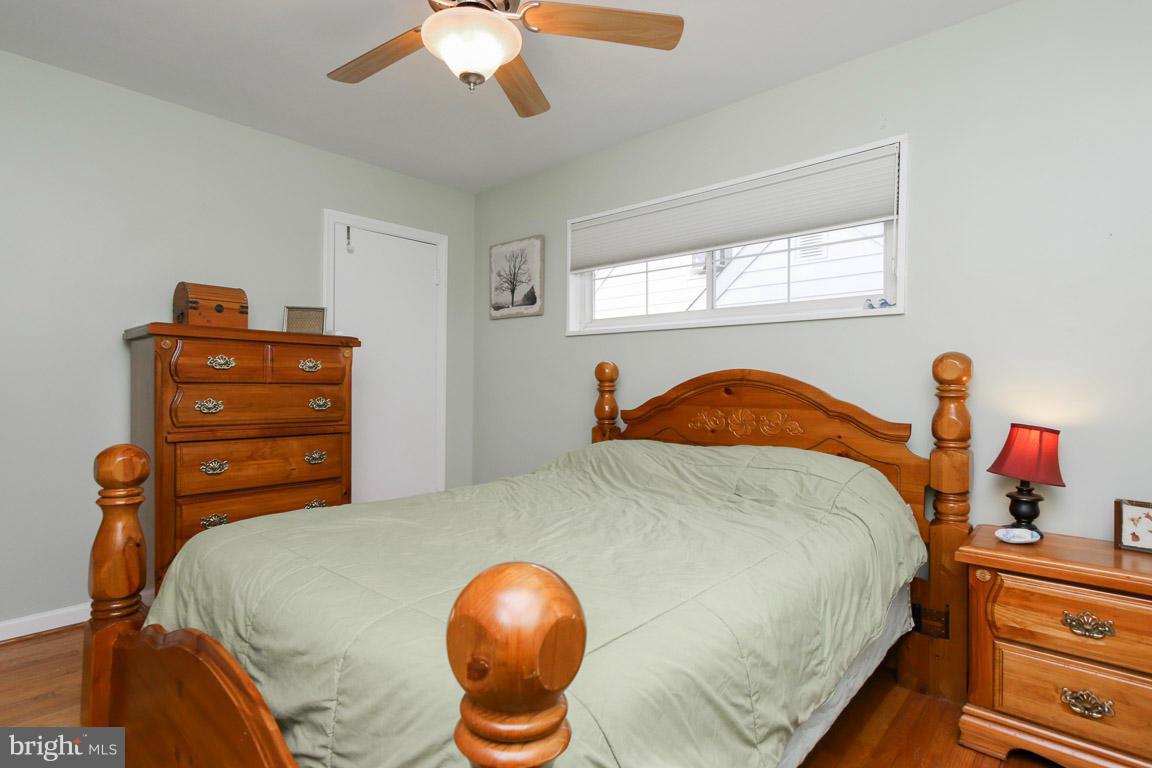 417 Kerwin Road Silver Spring, MD 20901 - Photo 16 of 30 a bedroom with a bed and wooden floor