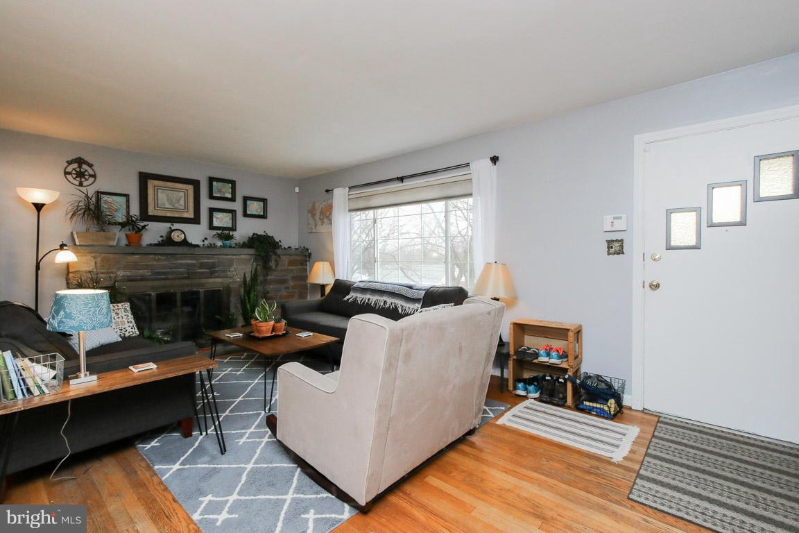 417 Kerwin Road Silver Spring, MD 20901 - Photo 3 of 30 a living room with furniture a fireplace and a table