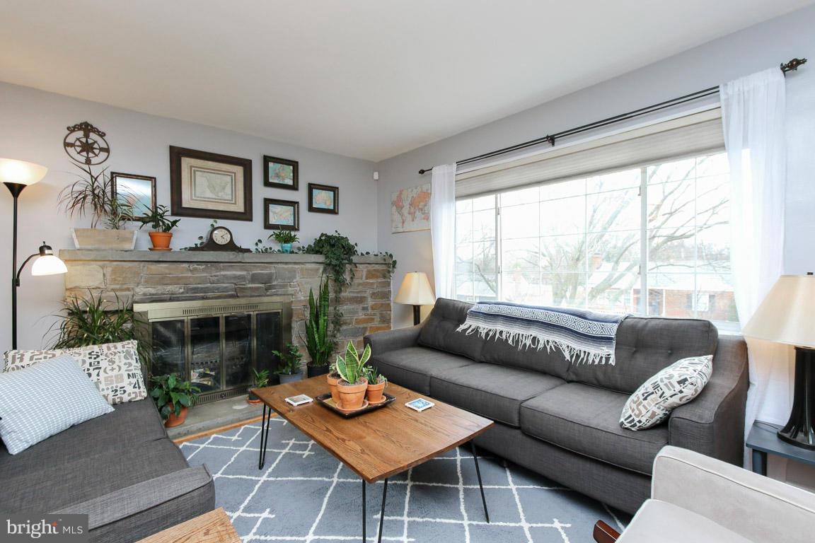 417 Kerwin Road Silver Spring, MD 20901 - Photo 5 of 30 a living room with furniture a large window and a fireplace