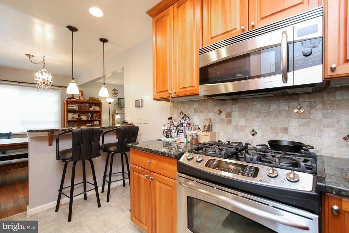417 Kerwin Road Silver Spring, MD 20901 - Photo 10 of 30 a kitchen with stainless steel appliances granite countertop a stove a sink and a microwave