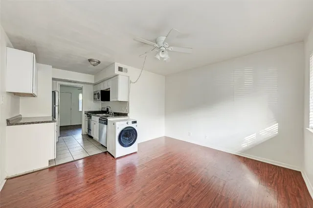 a view of kitchen with wooden floor electronic appliances and window