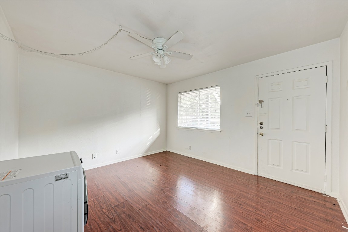 1010 West 23rd Street, Unit 5 Austin, TX 78705 - Photo 4 of 10 an empty room with wooden floor closet and windows