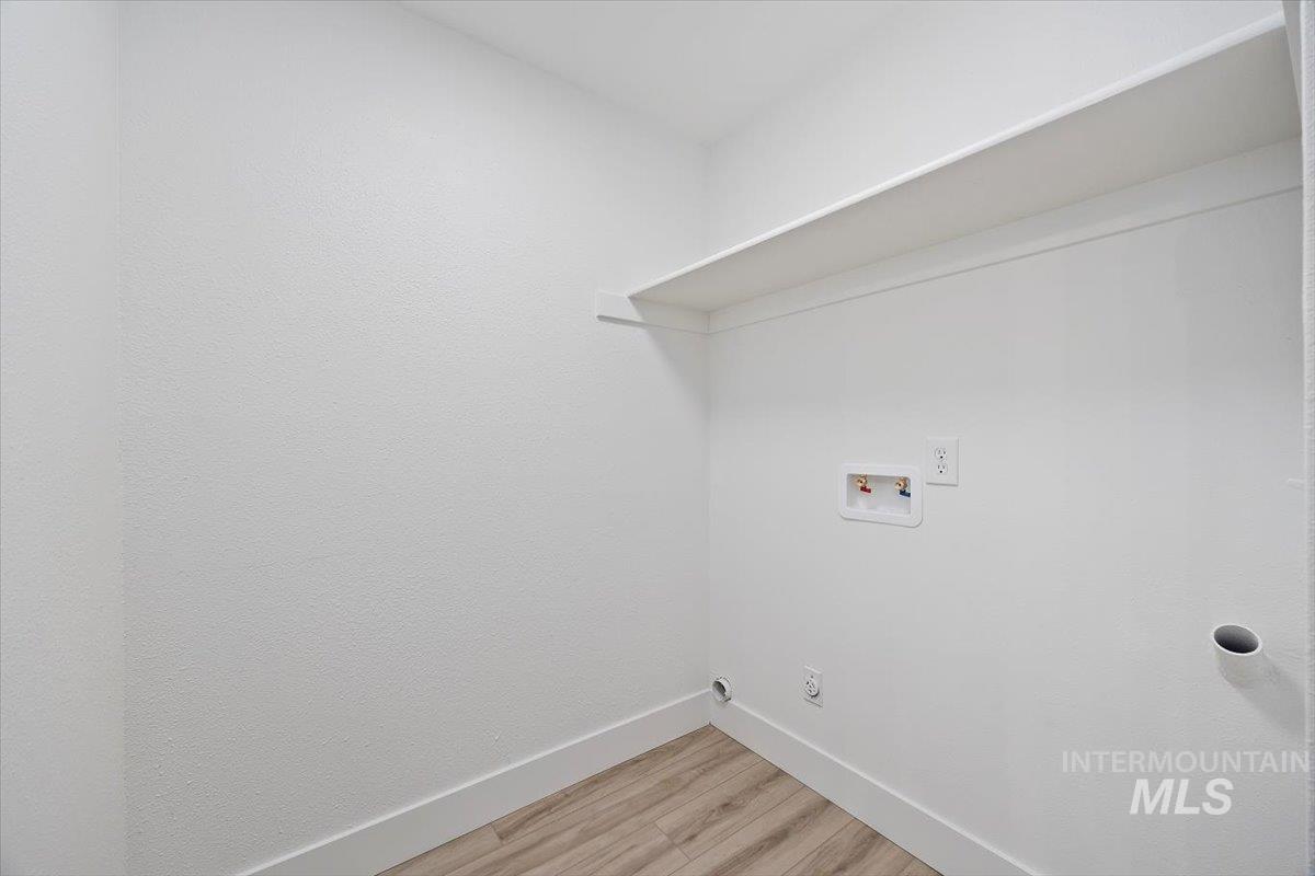 259 Pheasant Road West, Unit 3 Twin Falls, ID 83301 - Photo 13 of 24 Laundry room featuring light wood-type flooring and hookup for a washing machine