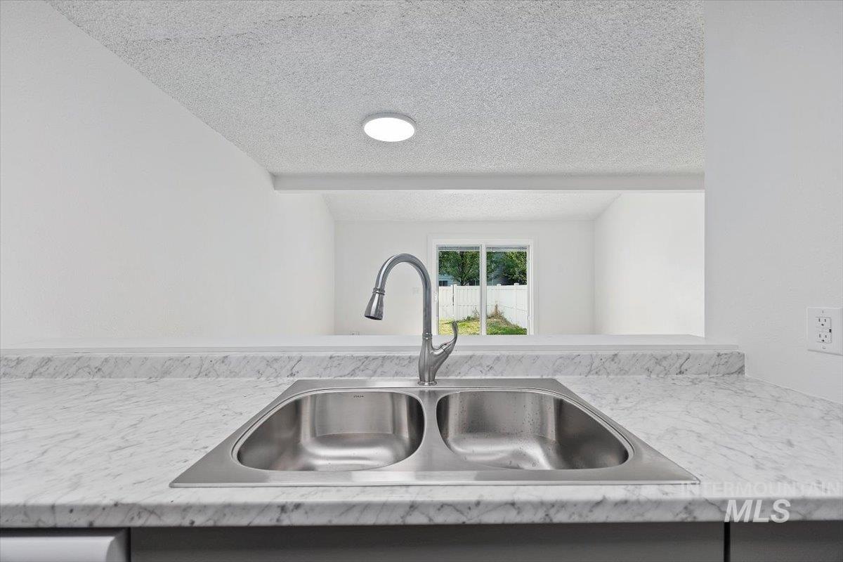 259 Pheasant Road West, Unit 3 Twin Falls, ID 83301 - Photo 9 of 24 Kitchen view of a sink and a textured ceiling