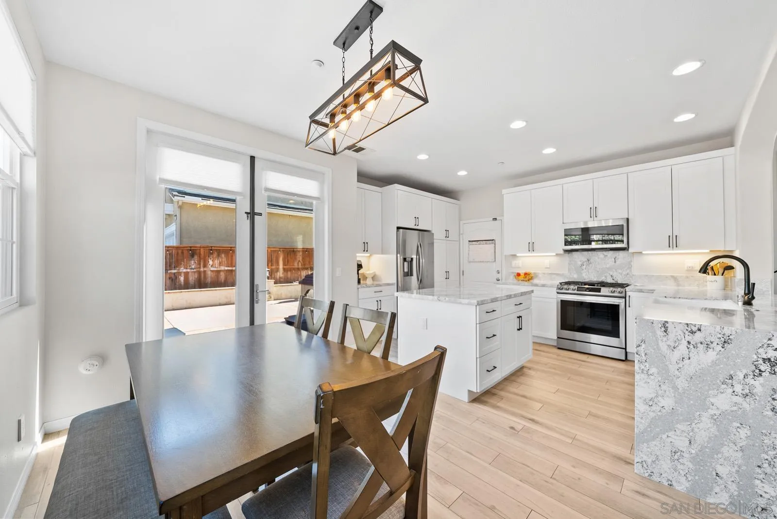 17083 Ralphs Ranch Road San Diego, CA 92127 - Photo 12 of 61 a view of a dining room with furniture window and wooden floor