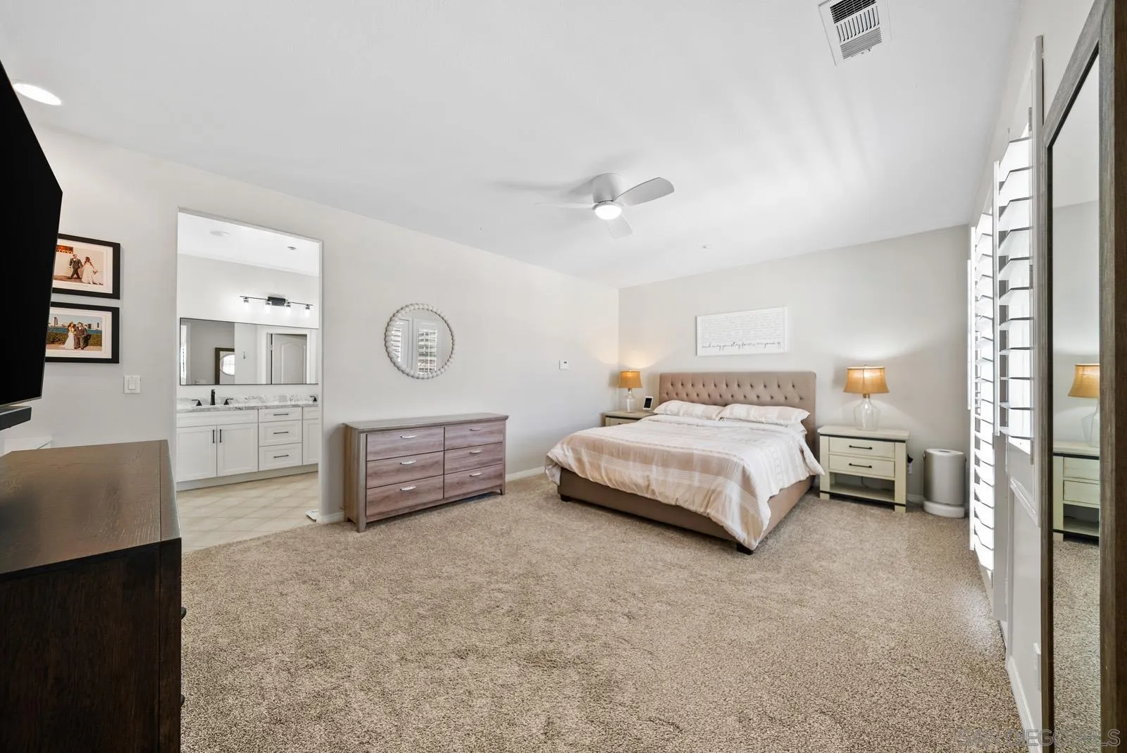 17083 Ralphs Ranch Road San Diego, CA 92127 - Photo 32 of 61 a bedroom with a bed and dresser with mirror