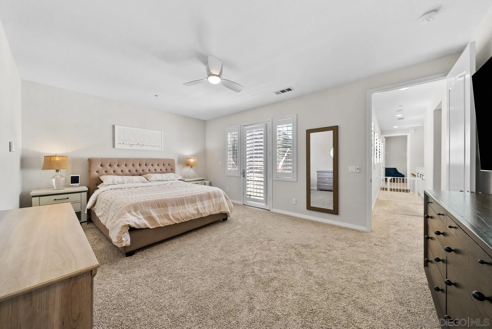 17083 Ralphs Ranch Road San Diego, CA 92127 - Photo 34 of 61 a spacious bedroom with a large bed and a chandelier