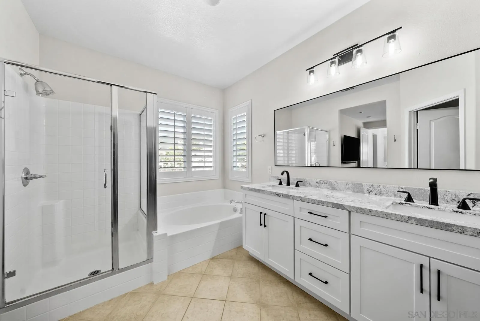 17083 Ralphs Ranch Road San Diego, CA 92127 - Photo 35 of 61 a bathroom with a granite countertop sink mirror and a bathtub