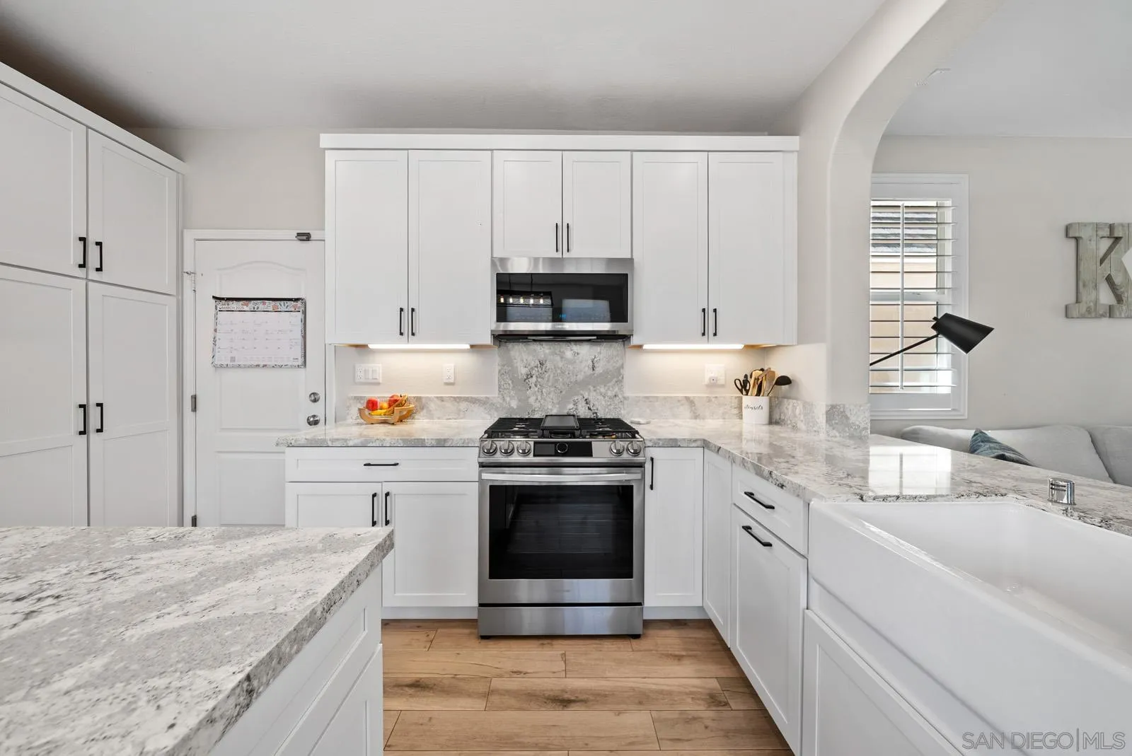 17083 Ralphs Ranch Road San Diego, CA 92127 - Photo 6 of 61 a kitchen with stainless steel appliances granite countertop a stove and a sink