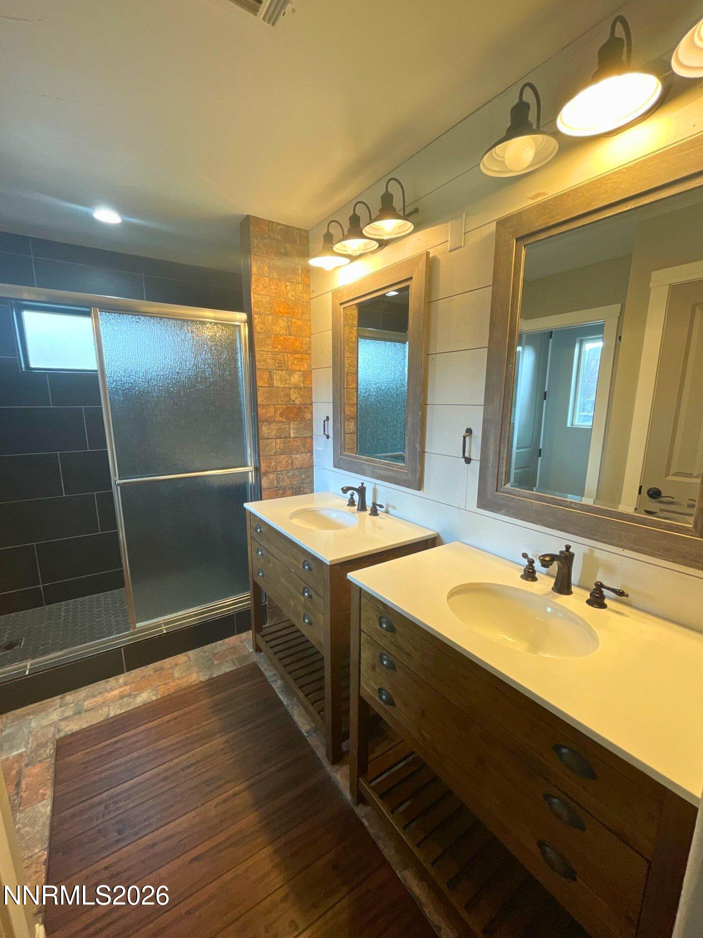 2205 Stowe Drive Reno, NV 89511 - Photo 15 of 17 a bathroom with a double vanity sink and a mirror